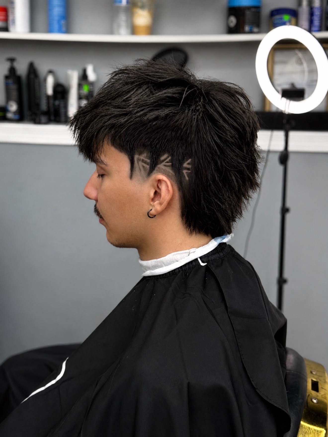 Shaggy cut with a freestyle shaved line design