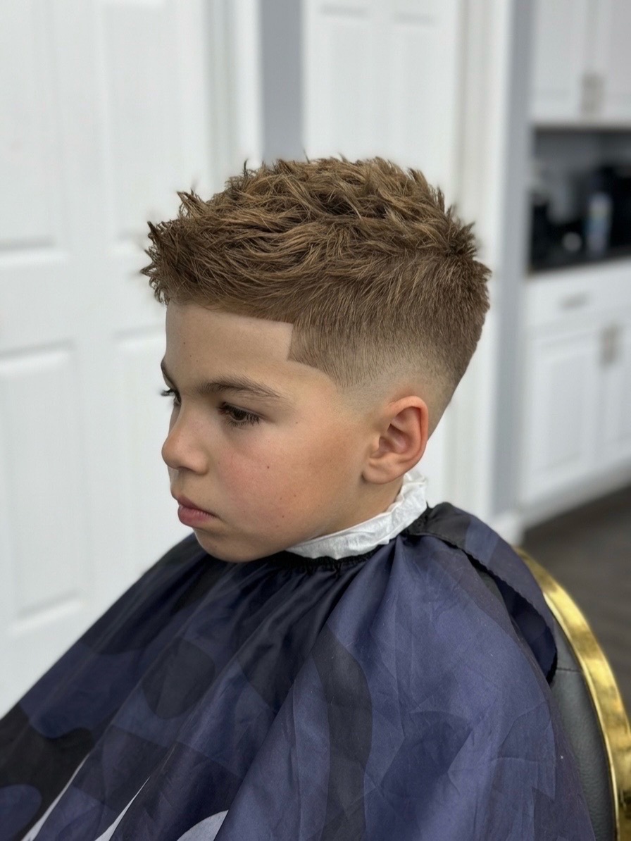 Kids cut with a skin fade and textured top