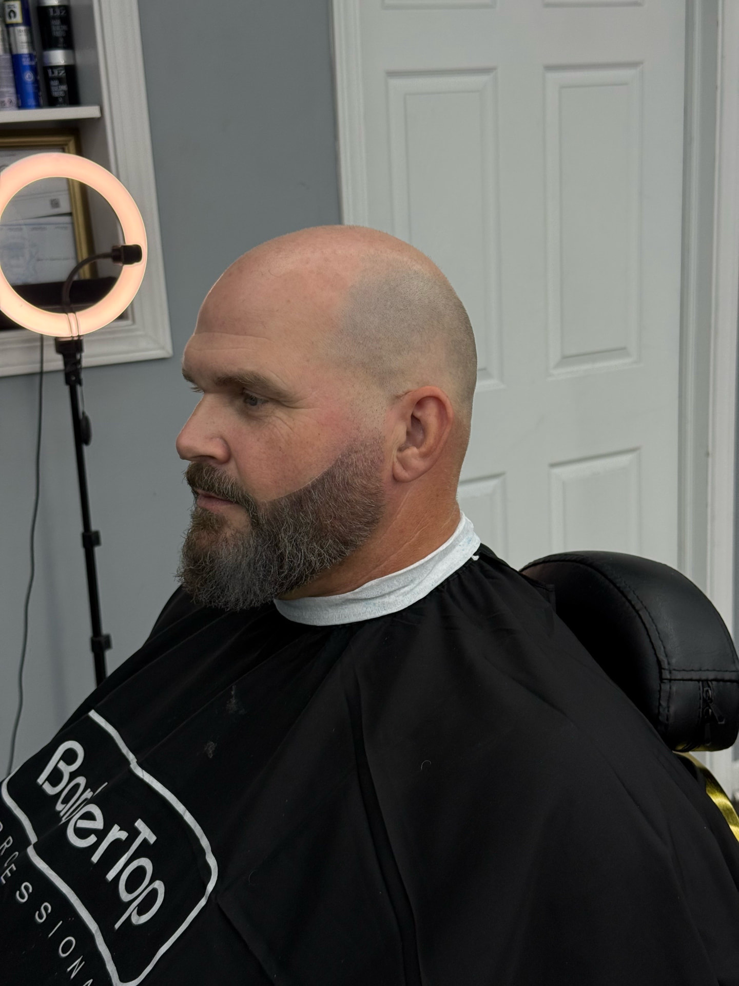 Bald fade with a sculpted full beard